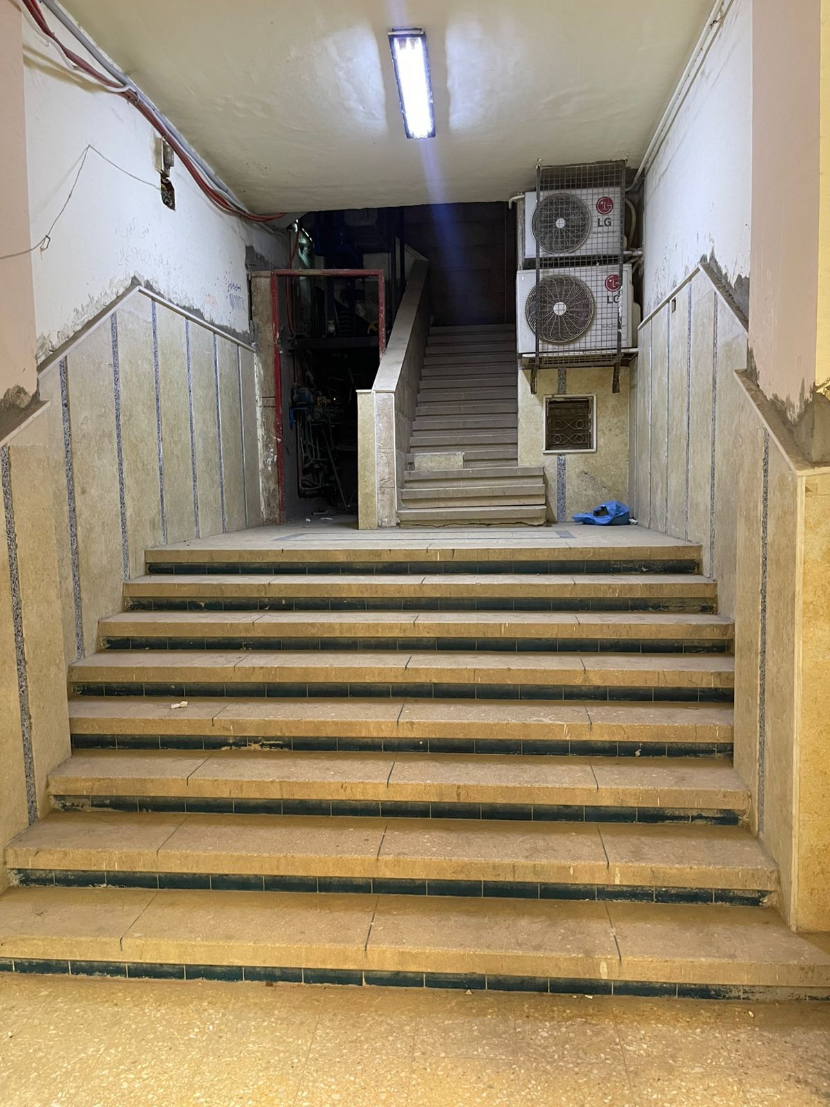 Image of an apartment complex with cars parked in front